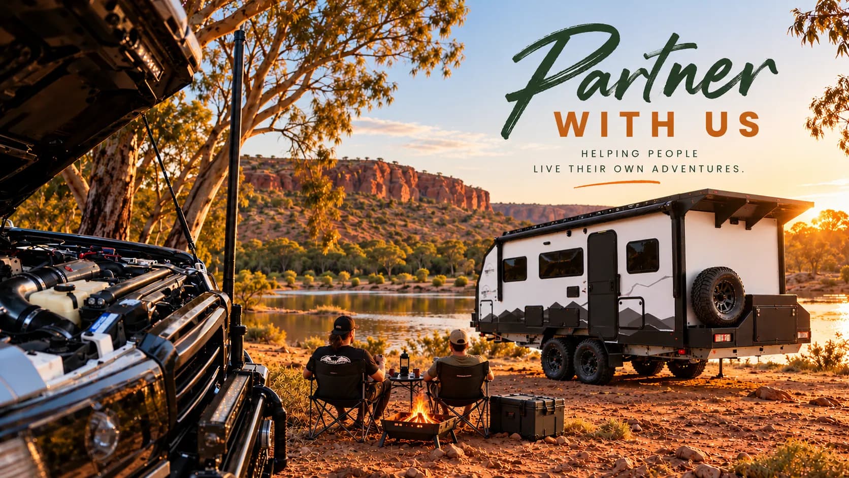 Two people by a campfire beside an off-road caravan and a 4x4 at a red-rock river camp at sunset, with the words Partner with us, helping people live their own adventures